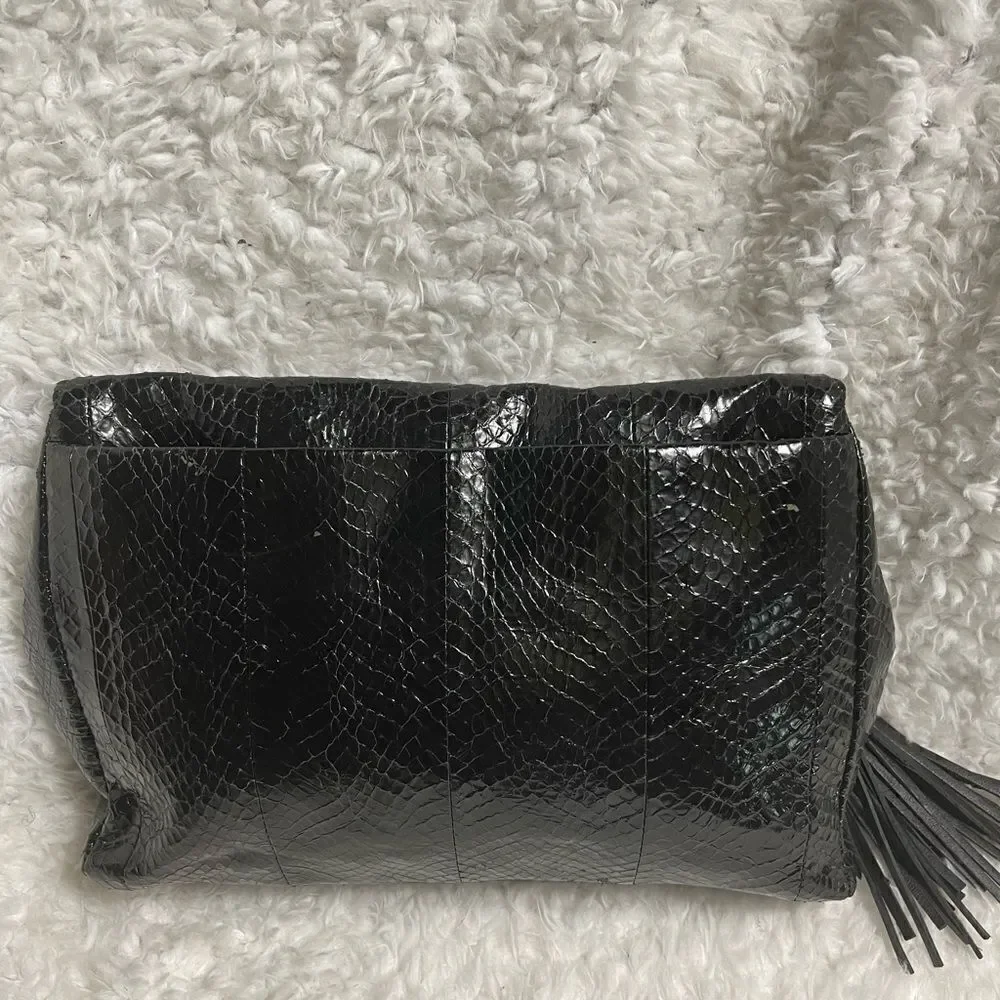 Rafe Black patent snake skin print clutch embellished with jewels and tassel .